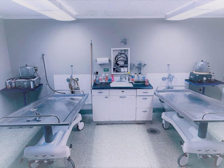A side-by-side view of a hydraulic embalming table and a folded dressing table, emphasizing space-saving design