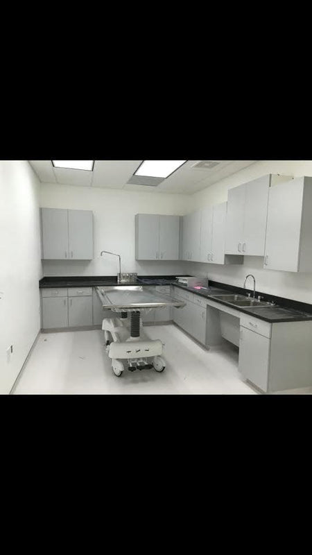 A side-by-side view of a hydraulic embalming table and a folded dressing table, emphasizing space-saving design